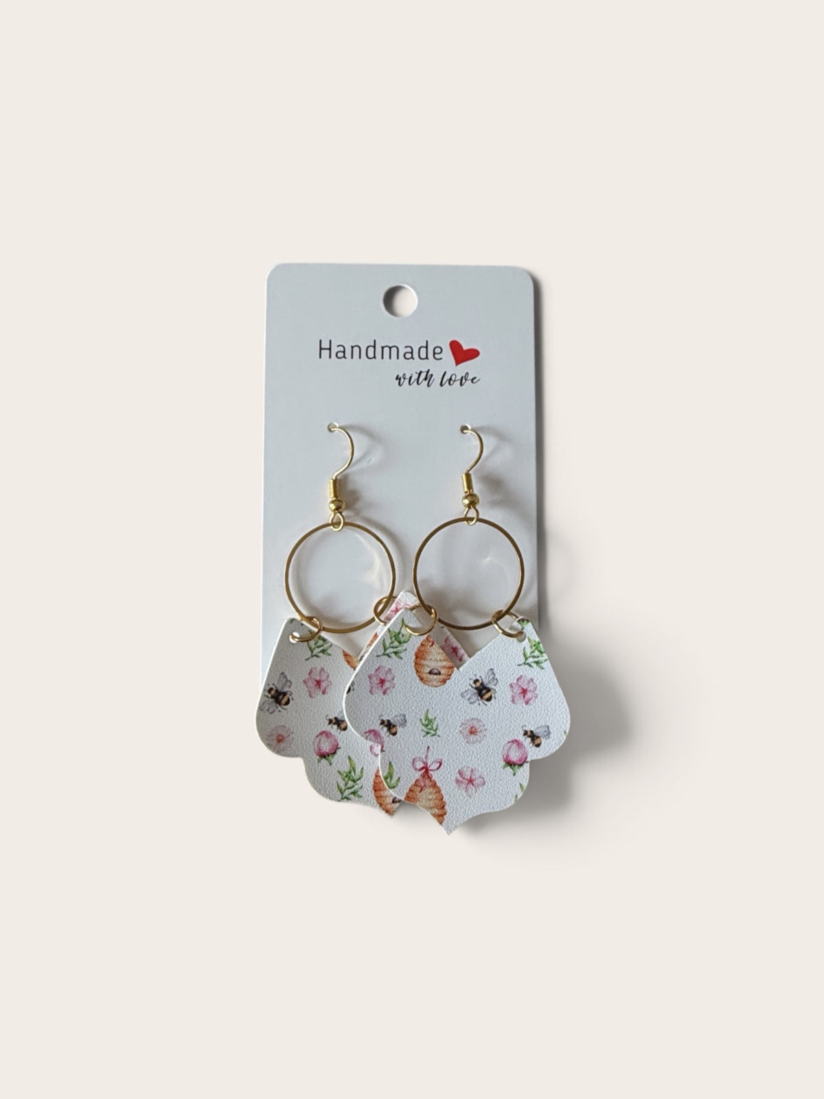 Roselee Glitz handmade teardrop dangle earrings featuring a bee, beehive, and pink floral print on faux leather.