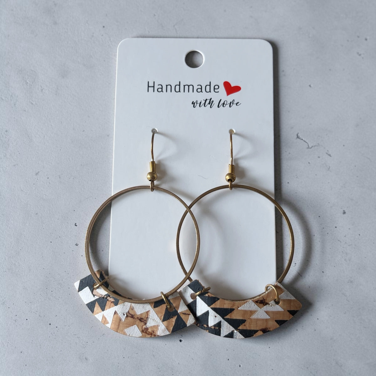 Roselee Glitz handmade geometric hoop earrings with black, white, and tan cork inlays on antique-gold metal hoops.