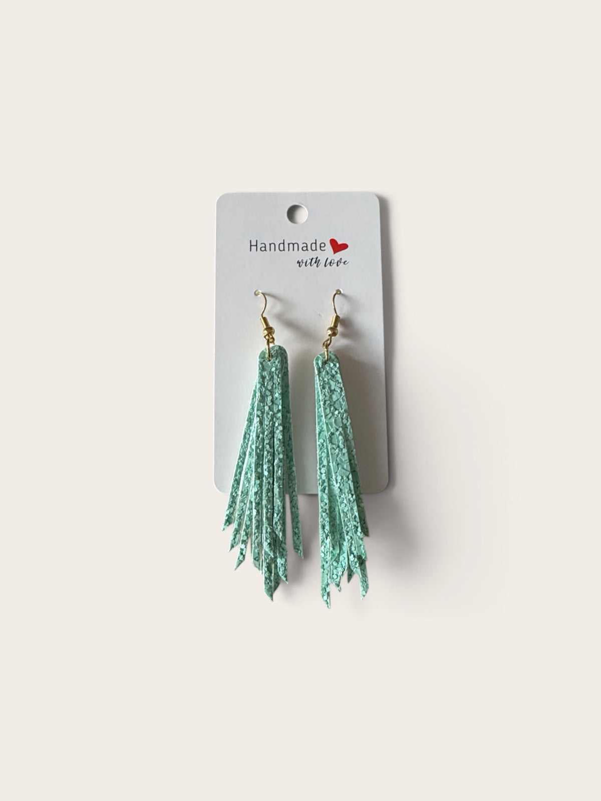 Roselee Glitz handmade mint green textured fringe drop earrings with gold-toned hooks on a display card.