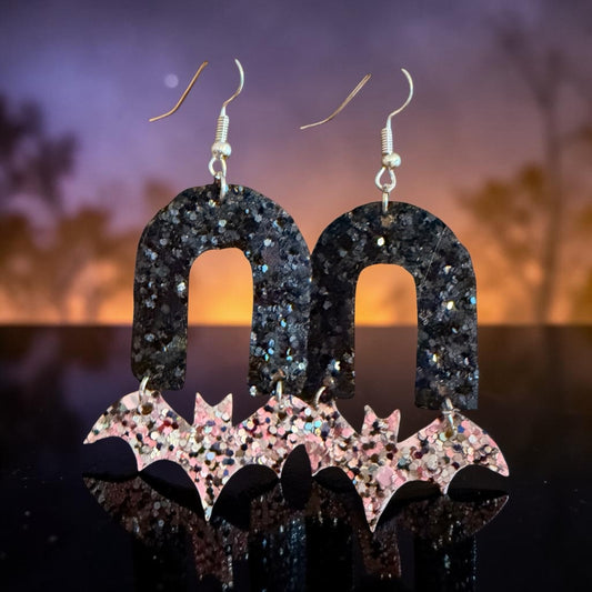 Roselee Glitz arch and bat dangle earrings featuring black glitter arches and sparkling pink silver bat charms