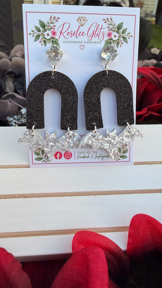 Roselee Glitz handmade dangle earrings featuring black glitter arches, silver glitter bats, and crystal stud toppers.