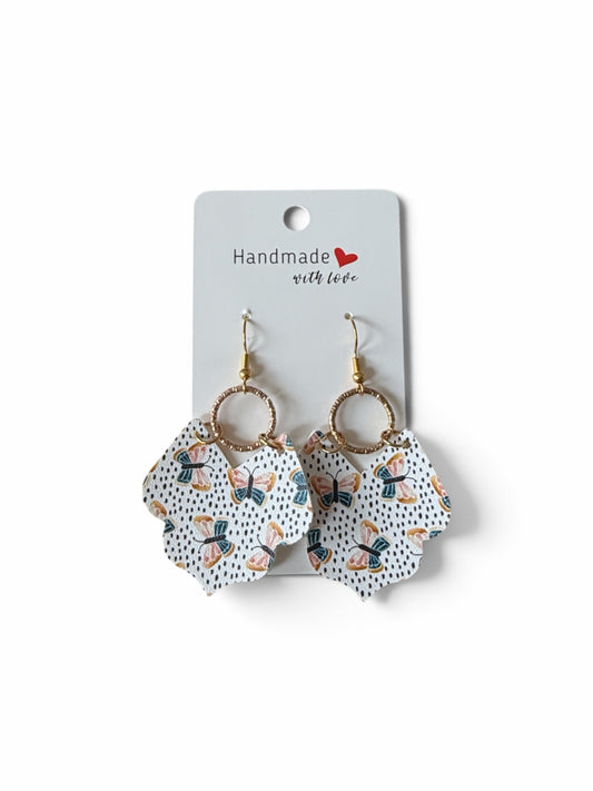 Roselee Glitz handmade drop earrings featuring a white butterfly and dotted pattern with gold-toned hardware