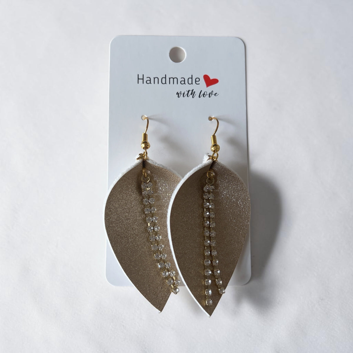 Roselee Glitz champagne-gold faux leather leaf-shaped dangle earrings with shimmering crystal rhinestone chain accents