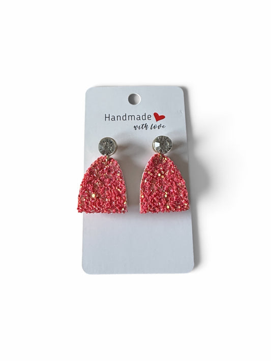 Roselee Glitz handmade coral-pink glitter arch dangle earrings with sparkling crystal stud tops on a display card.