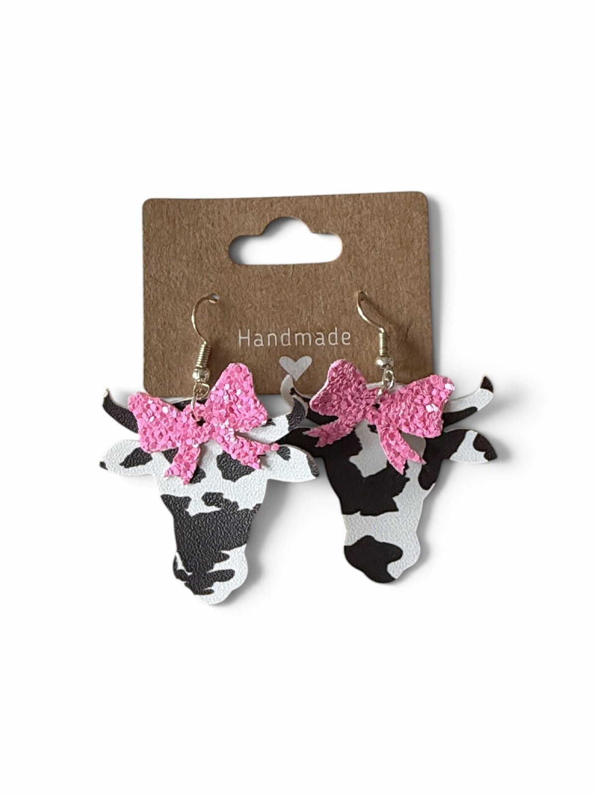 Roselee Glitz faux leather cow head dangle earrings with black and white print and sparkling pink glitter bows.