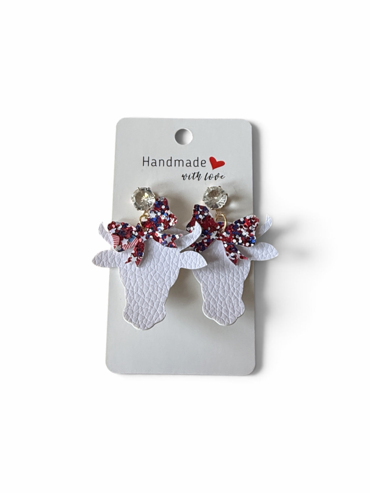 Roselee Glitz handmade white faux leather cow head dangle earrings with patriotic red white and blue glitter bows