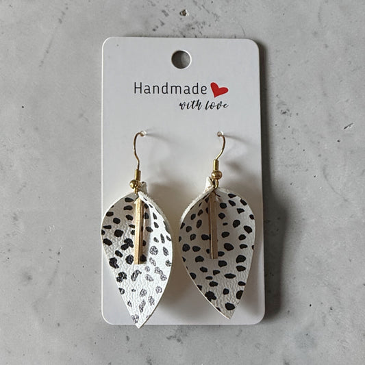 Roselee Glitz handmade leaf-shaped faux leather drop earrings with a black and white dalmatian print and gold bar.