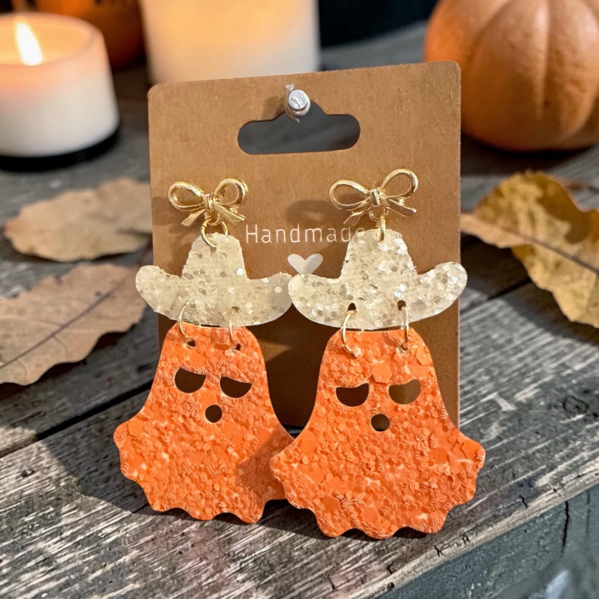 Roselee Glitz handmade ghost cowboy earrings with orange glitter ghosts, white glitter hats, and gold-tone bows.