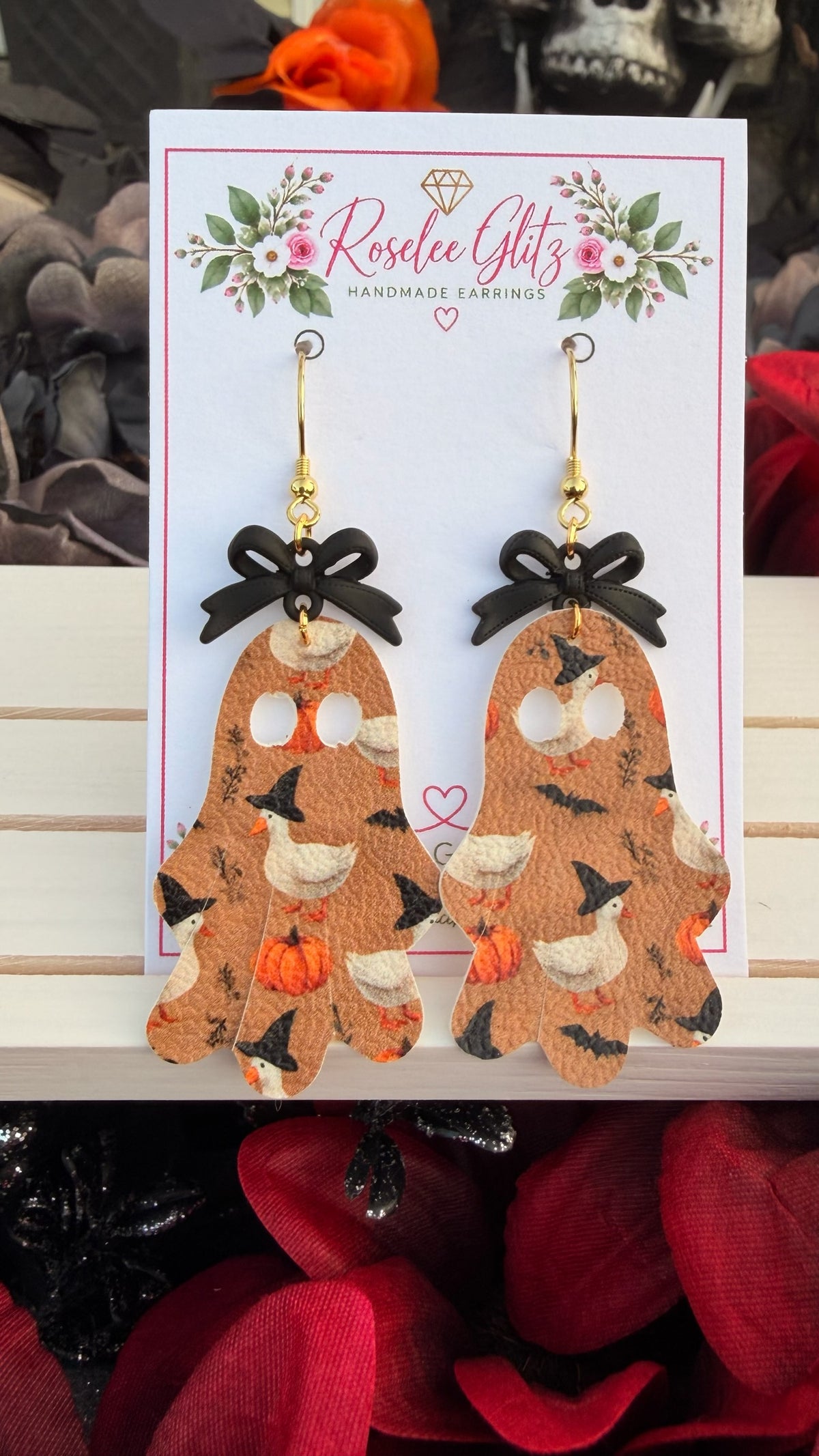 Roselee Glitz ghost-shaped dangle earrings featuring a duck and pumpkin print with black bows on a display card.