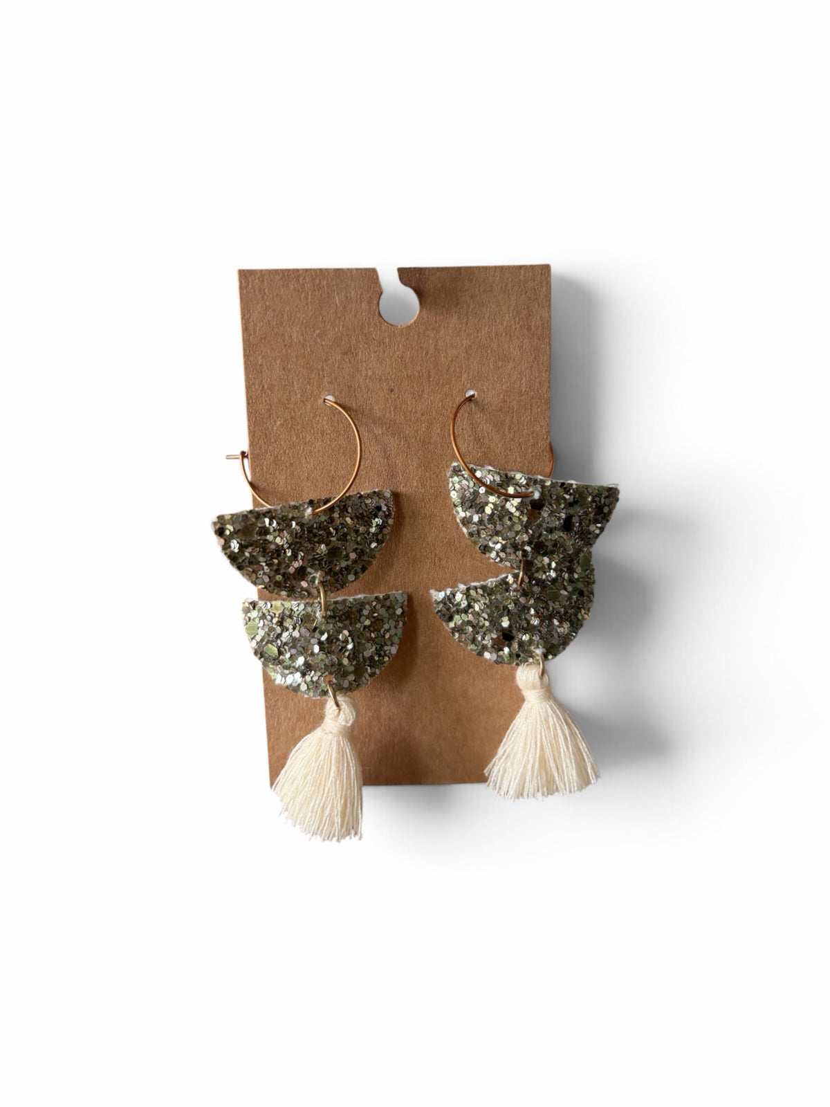 Roselee Glitz crescent drop earrings with gold hoops, silver glitter semi-circles, and cream-colored tassels.