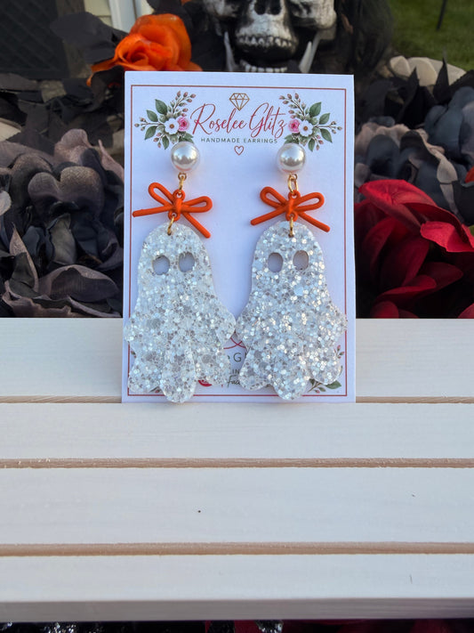 Roselee Glitz glitter ghost dangle earrings with orange bows and pearl studs on a branded display card