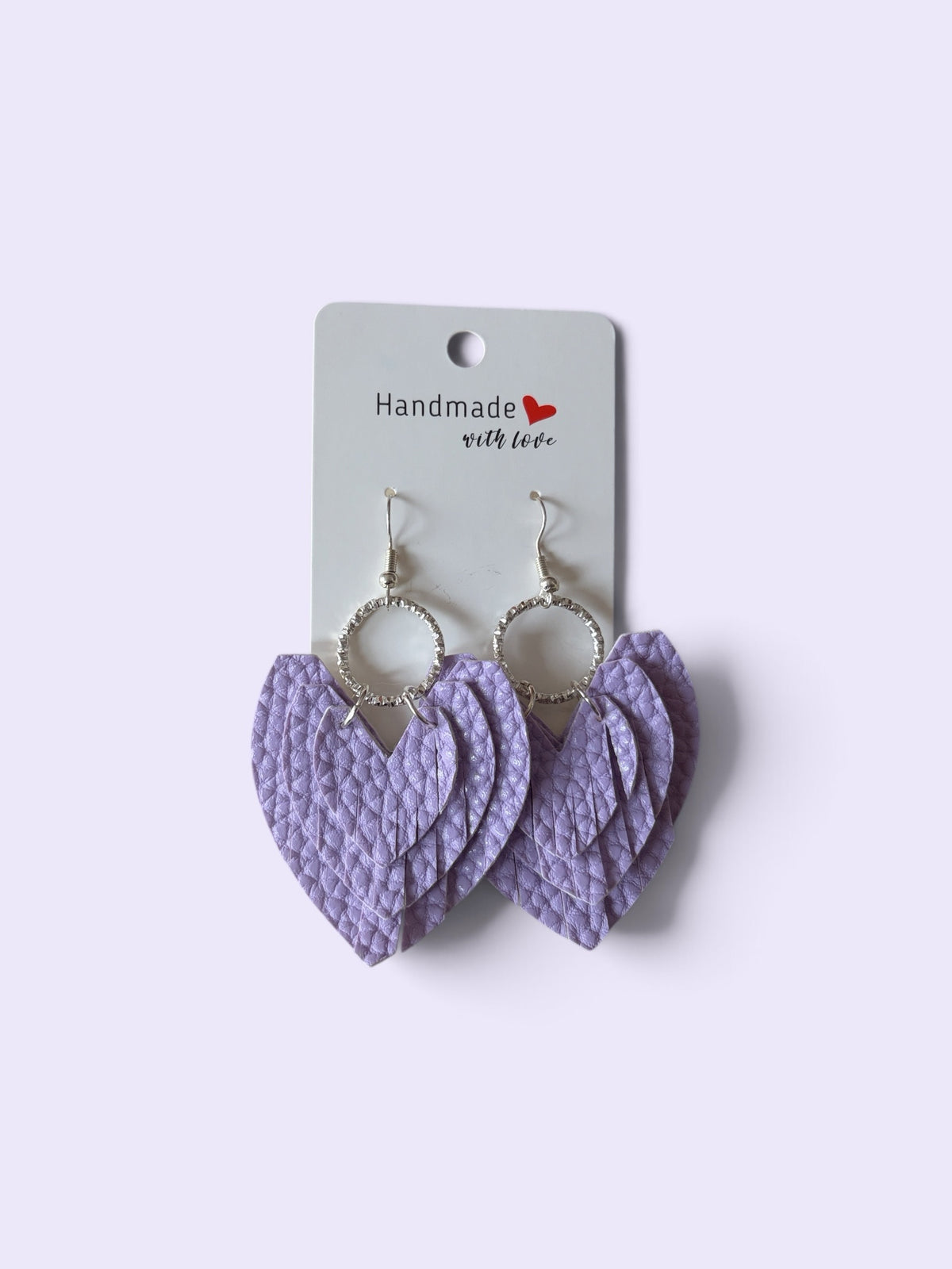 Roselee Glitz lavender faux leather layered heart drop earrings with silver-toned circular hoops on a display card.