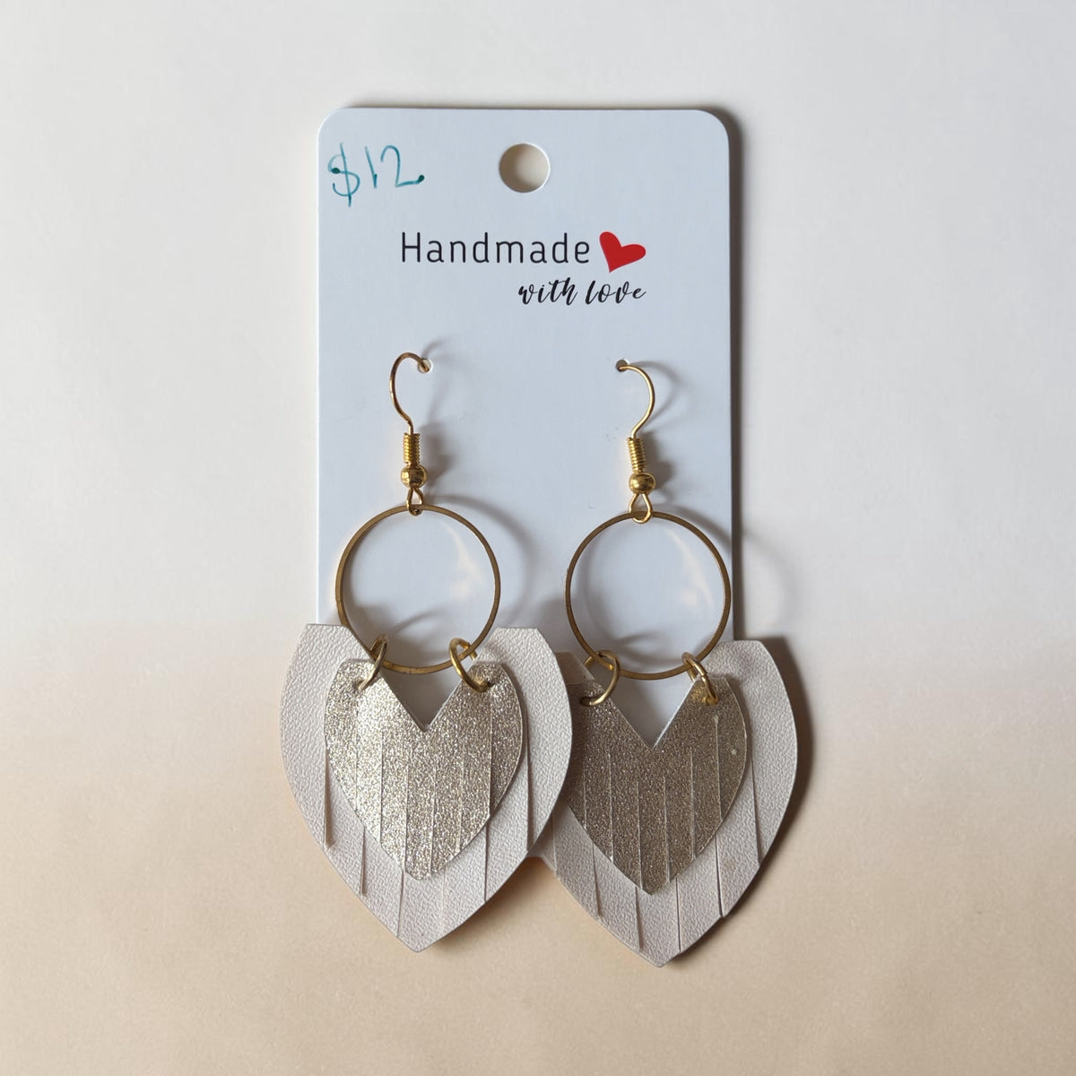 Roselee Glitz handmade layered heart fringe dangle earrings in cream leather and metallic gold on display card