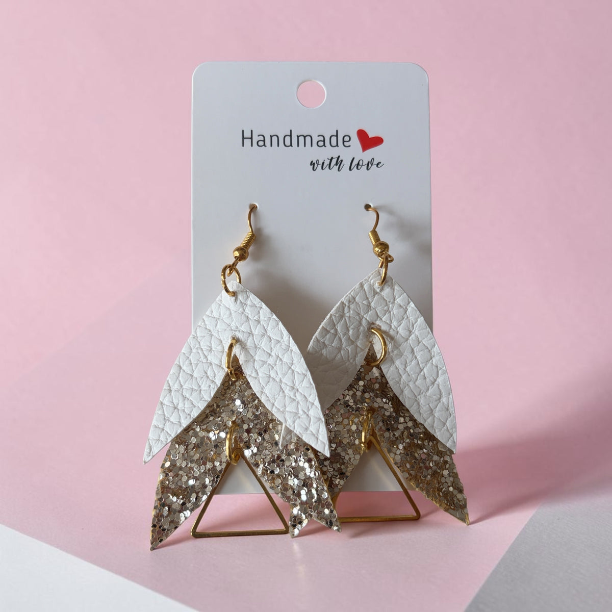 Roselee Glitz layered teardrop dangle earrings featuring white pebbled faux leather and gold glitter geometric shapes.