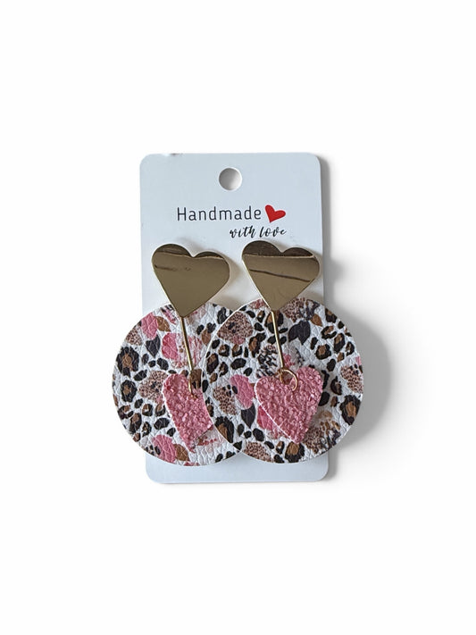 Roselee Glitz handcrafted dangle earrings featuring leopard print discs, gold hearts, and textured pink heart charms.