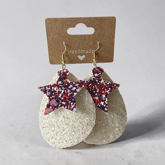 Roselee Glitz handmade teardrop earrings with white glitter base and red, white, and blue star accents on hooks.