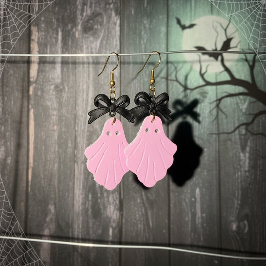 Roselee Glitz pastel pink faux leather ghost dangle earrings with black bows and gold-toned fishhook wires.