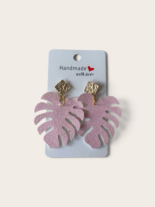 Roselee Glitz handmade monstera leaf dangle earrings in pink glitter with textured gold-tone geometric studs.