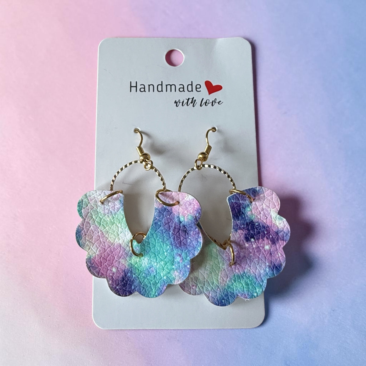 Roselee Glitz scalloped faux leather drop earrings with a purple, blue, and teal galaxy print and gold hardware.