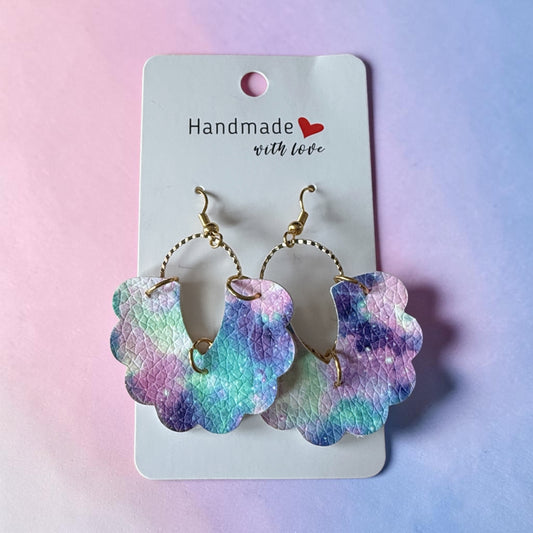 Roselee Glitz scalloped faux leather drop earrings with a purple, blue, and teal galaxy print and gold hardware.