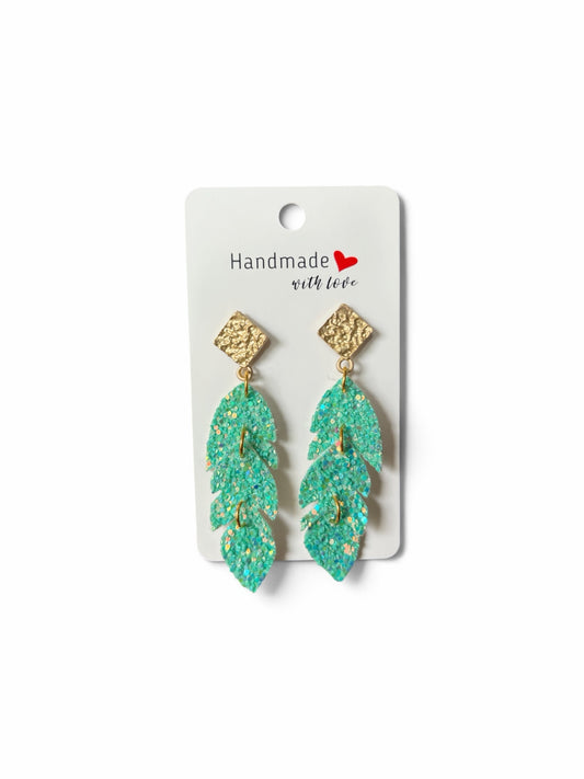 Roselee Glitz handmade triple-leaf dangle earrings featuring shimmering teal glitter and textured gold-tone studs.
