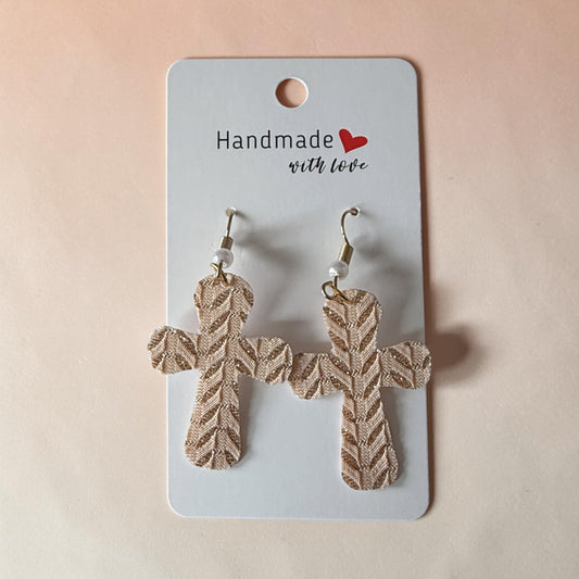 Roselee Glitz gold-tone textured cross dangle earrings with a herringbone pattern on a handmade display card.