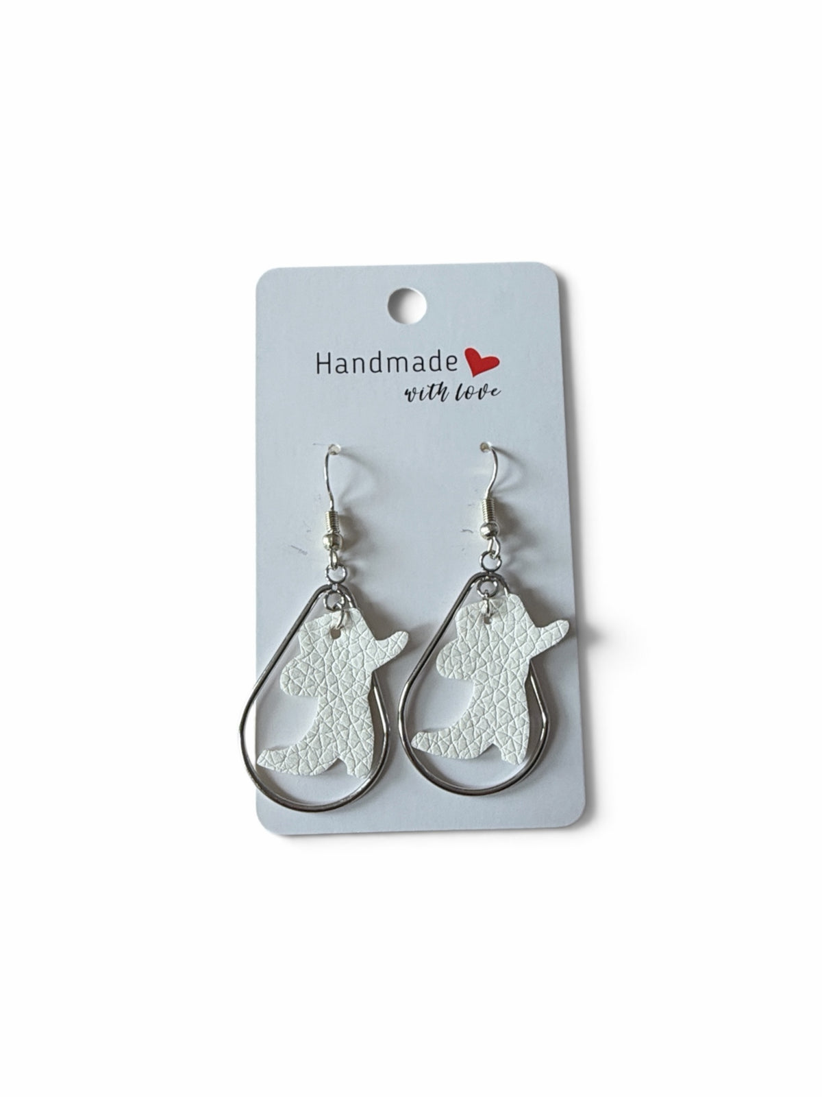 Roselee Glitz white faux-leather cowboy boot earrings featuring a silver-toned teardrop frame on a display card.